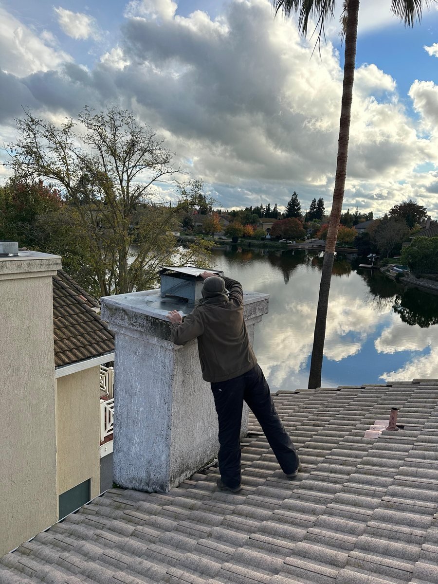 Roof-level chimney inspection in progress