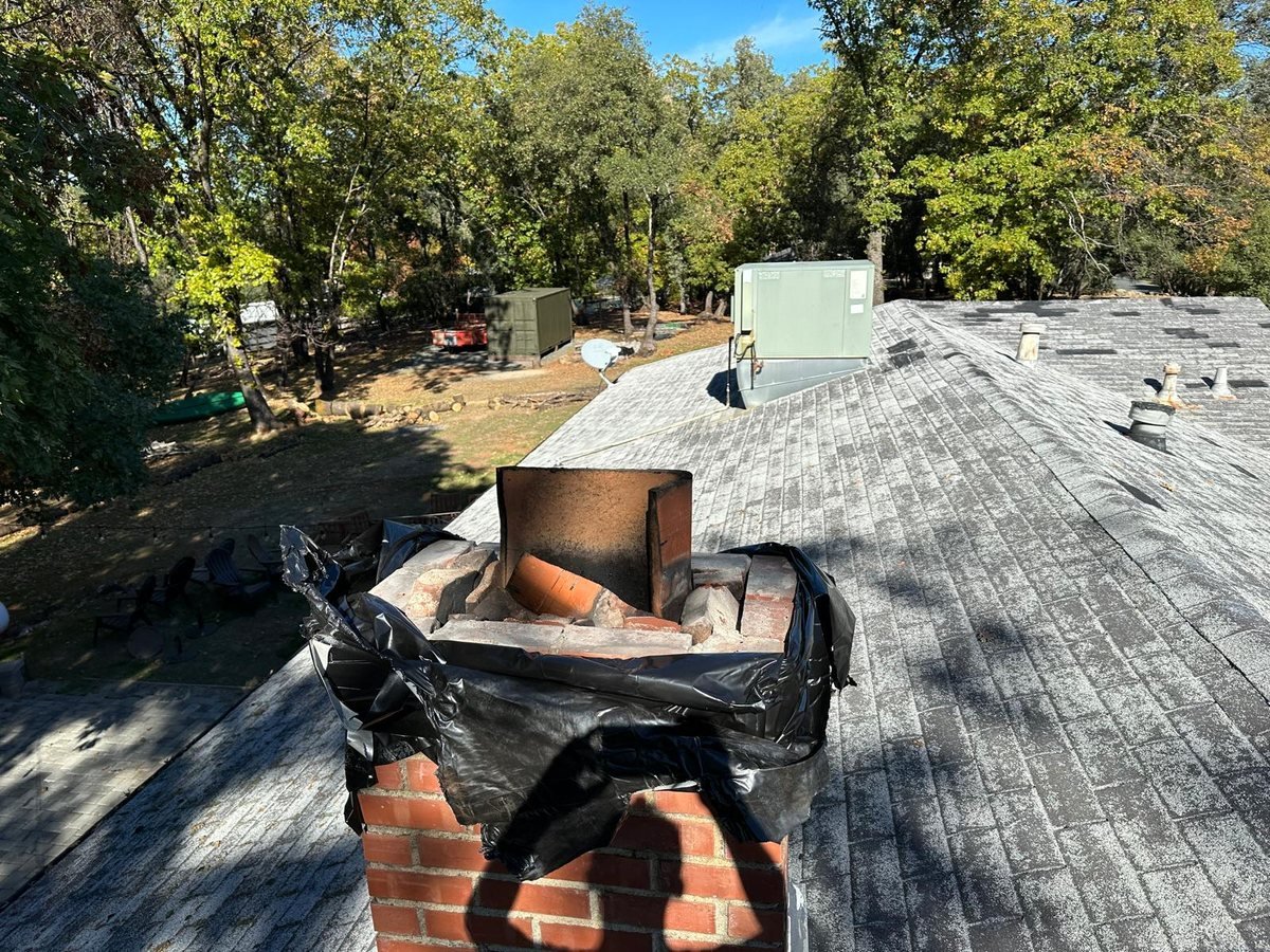 Newly fitted stainless chimney cap on a roof-mounted flue